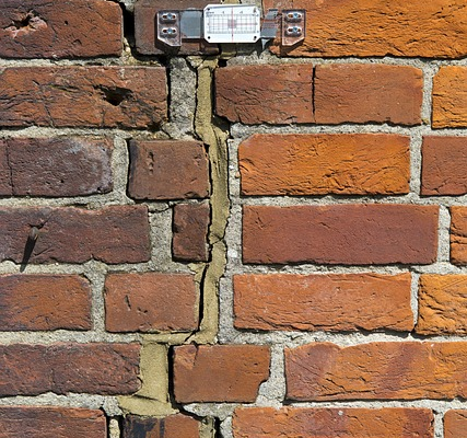 Chartered surveyor preparing Expert Witness Report under CPR Part 35 with supporting technical evidence and photographs.