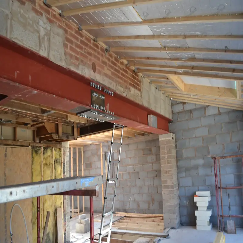 Structural engineer preparing steel and timber beam design calculations for building support.